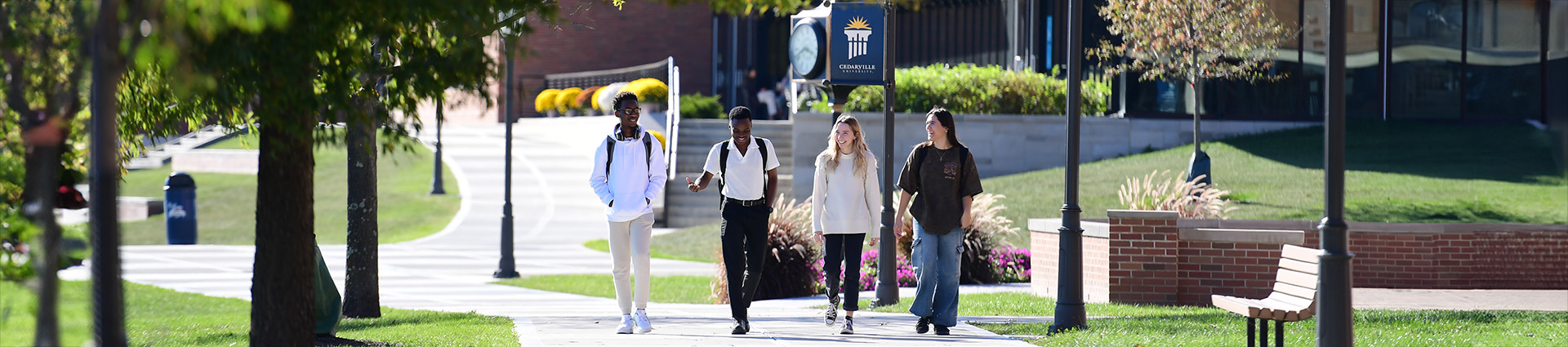Students walking along a sidewalk on the campus of Cedarville University.
