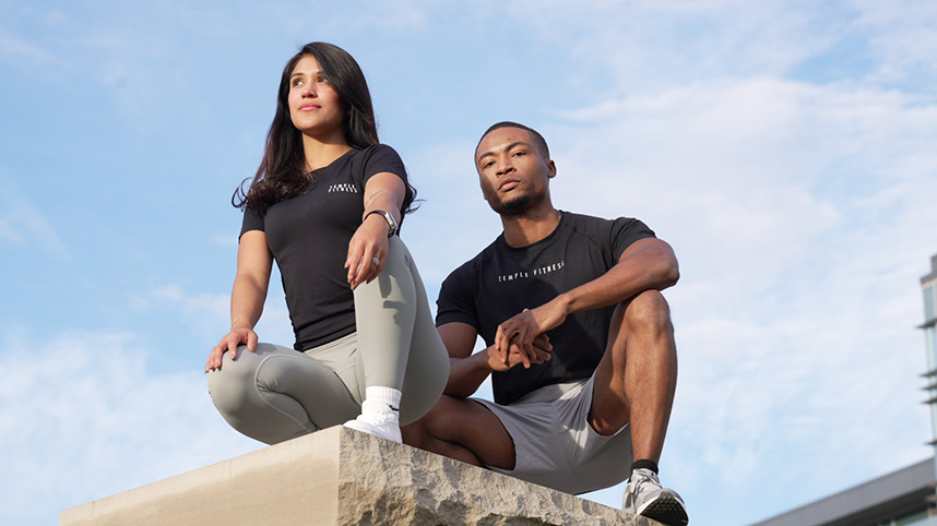 A male and female model, each wearing Temple Fitness clothing.