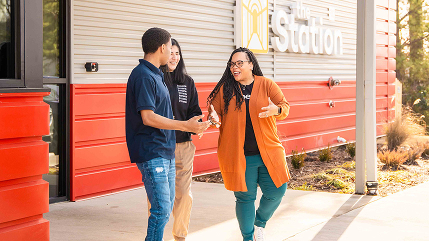 Female worker greets young man arriving at Immerse Arkansas' Station in Little Rock.