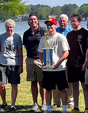 Students and professor with trophy.