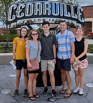 Trish White and her family pose for a photo at the Stinger statue on Cedarville's campus.