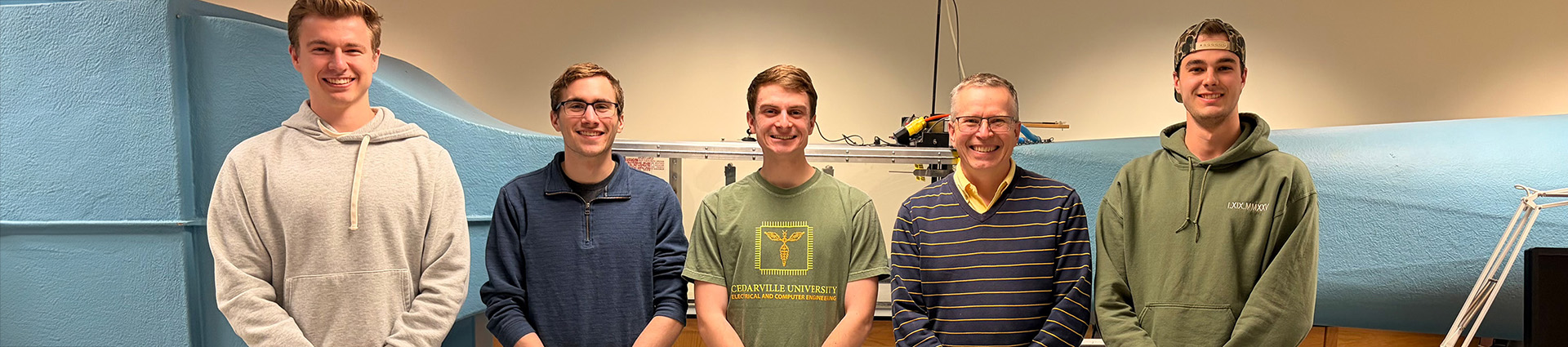 The design team for the new wind tunnel at Cedarville University poses for a photo in front of the wind tunnel.