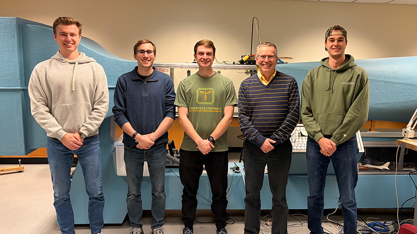 The design team for the new wind tunnel at Cedarville University poses for a photo in front of the wind tunnel.