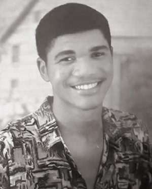 Dr. Lou Lilite smiles for the camera as a young man in Haiti.