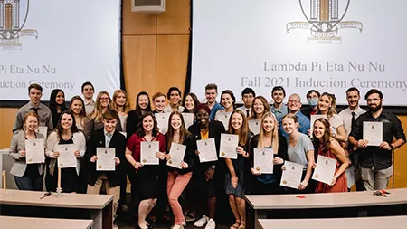 Lambda Pi Eta inducts students during ceremony at Cedarville University.