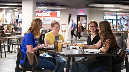 Cedarville students eating together in a cafe