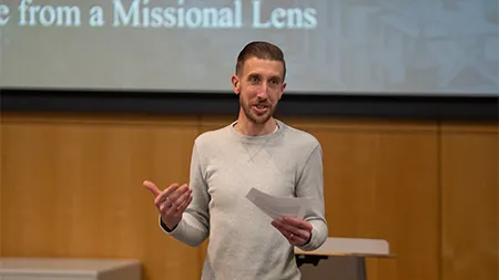 Cedarville University speaker presenting from a missional perspective during a campus lecture event.