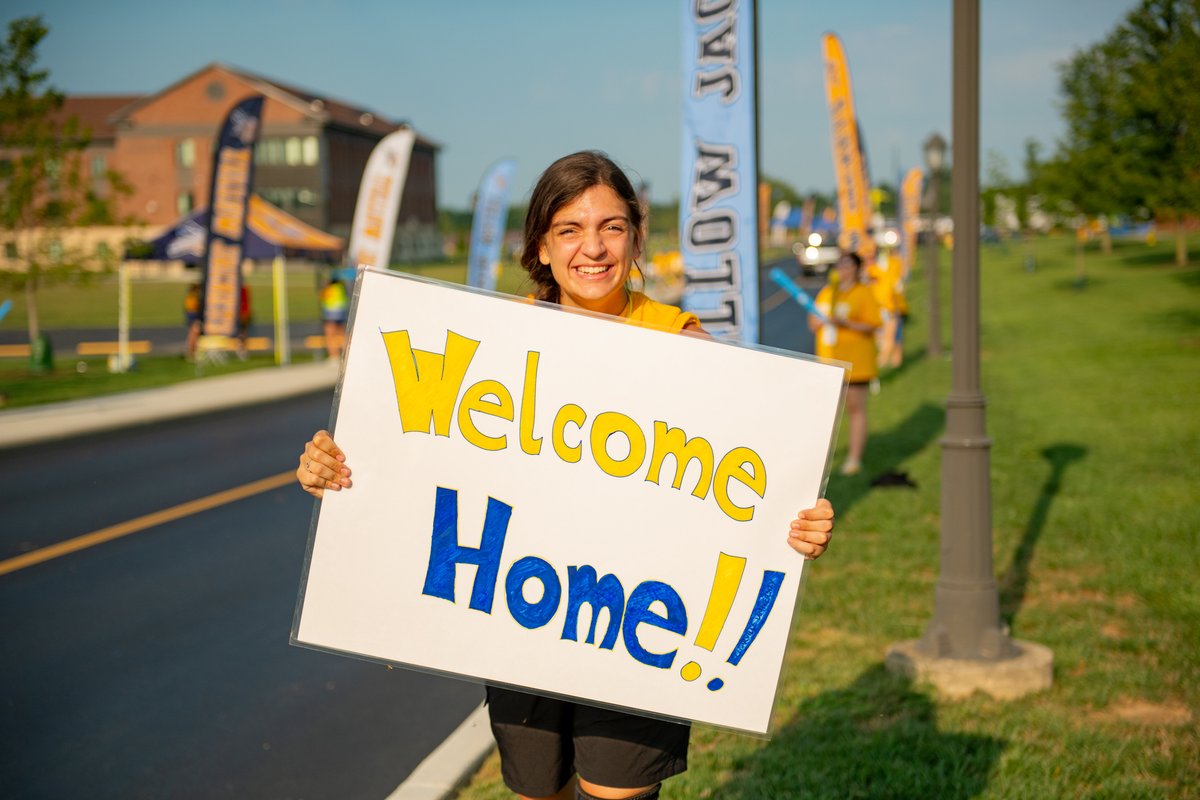 Cedarville student holds welcome home sign as new students come to campus.