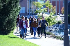 Group of students walking on sidewalk