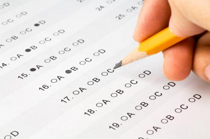 pencil in hand completing standardized test answers