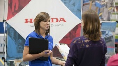 Woman talking to a student at a career fair
