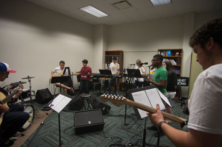 Students practice playing in a band together