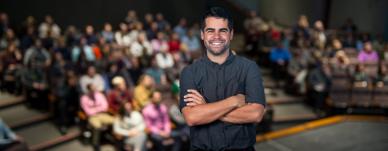 Man smiling in lecture hall