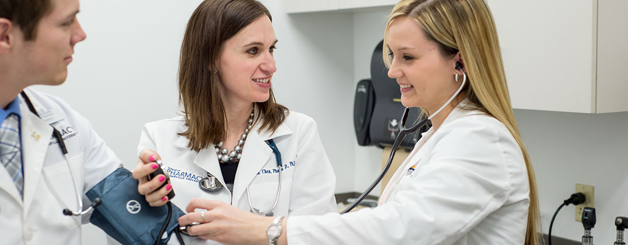 Female pharmacy majors take blood pressure