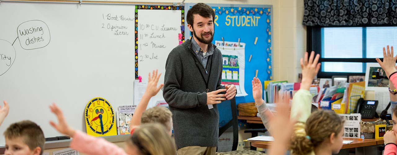 Male education student helps with class as part of field experience