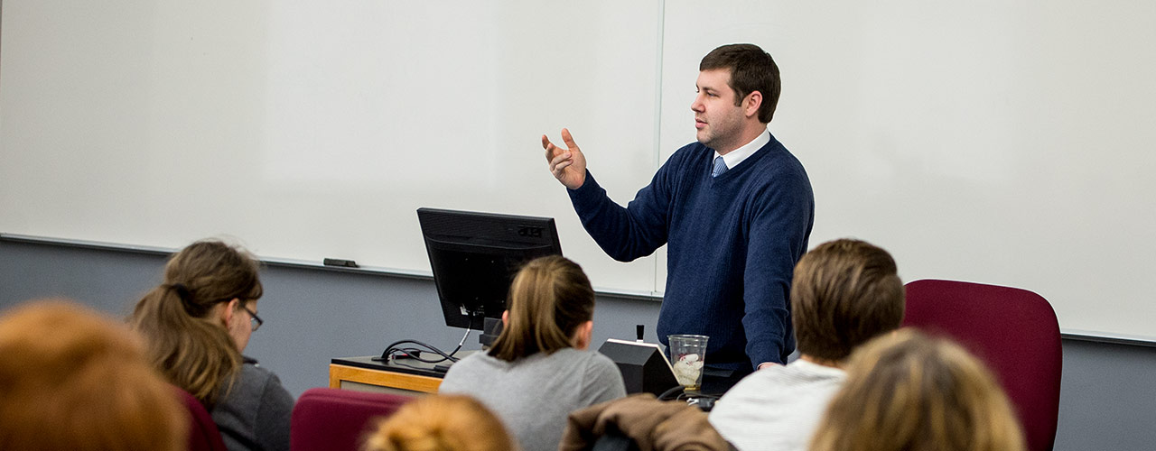 Honors professor lectures to students in class