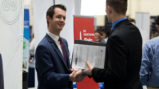 Employer talks with student during career fair