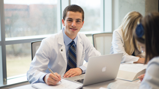 Male pharmacy student using a laptop