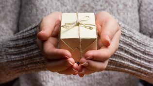 Person holding a small present