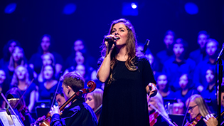 Female student singing at Cedarville's night of worship event