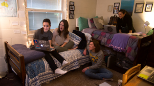 Four female students hanging out in one of Cedarville's dorm rooms