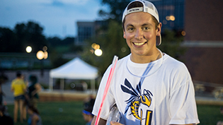 A male Cedarville student smiles at a campus event