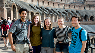 Students stand in front of colosseum