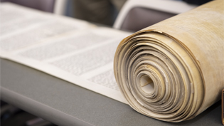 Image of Torah scroll on table