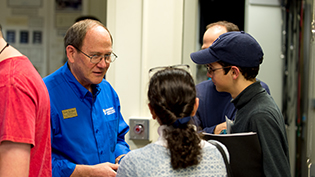 An engineering professor talks with a prospective student