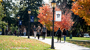 Students walk through Cedarville's scenic campus during the fall