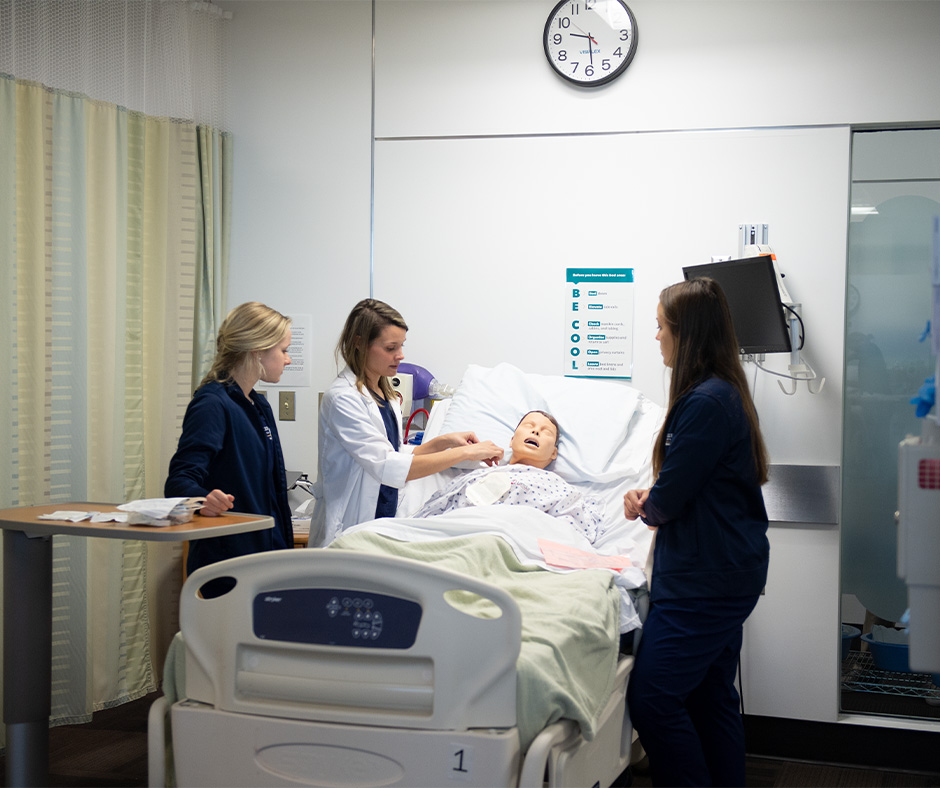 Nursing students working with simulated patient.