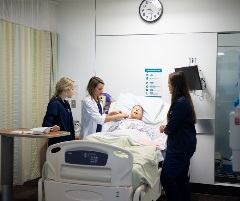 Nursing students working with simulated patient.