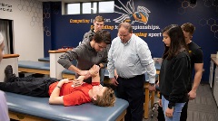 Students watching athletic training professor demonstrate procedure
