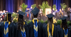 Group of graduates facing the stage