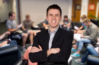 Man standing in front of small group study