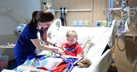 Nurse caring for sick child in hospital