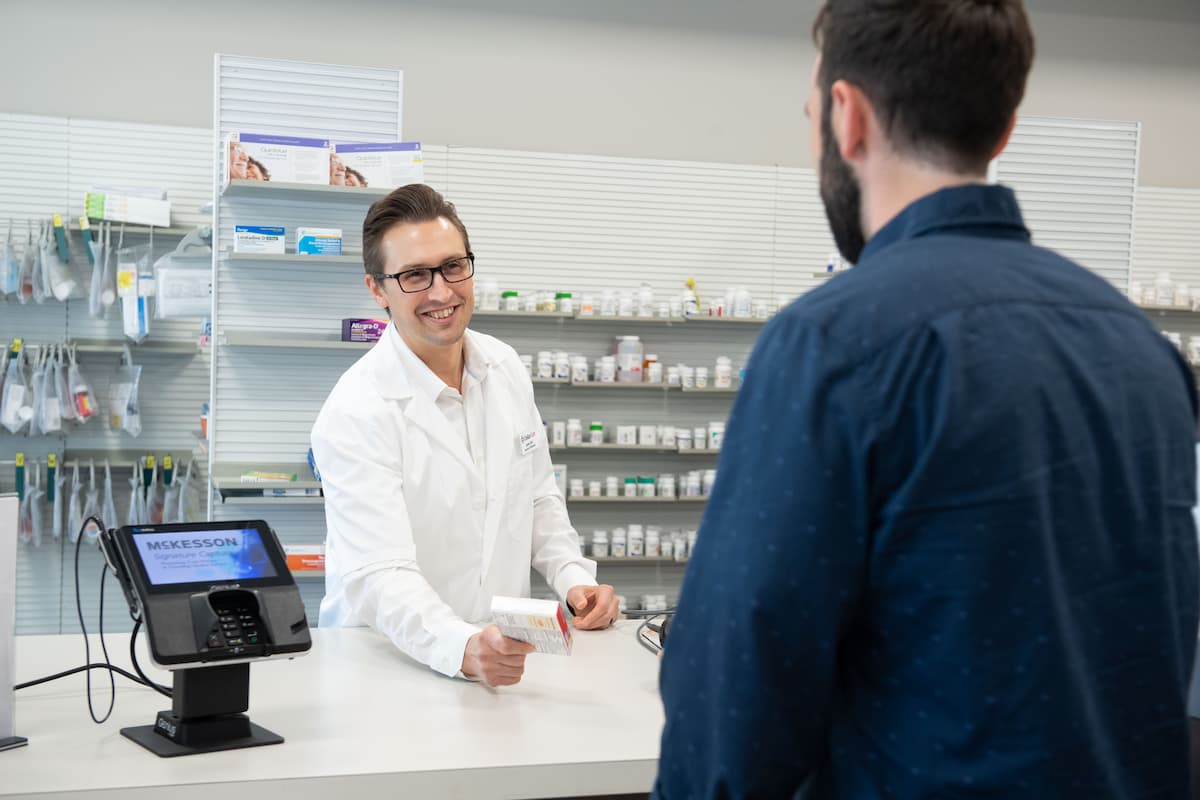 Pharmacist assisting a customer with a question about and over-the-counter product