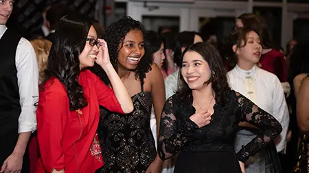 Group of three girls at the Embassy Gala hosted by international student organization