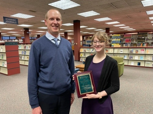 The winner of the Centennial Library Scholarship receiving her award