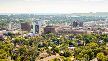 A city surrounded by trees and hills.