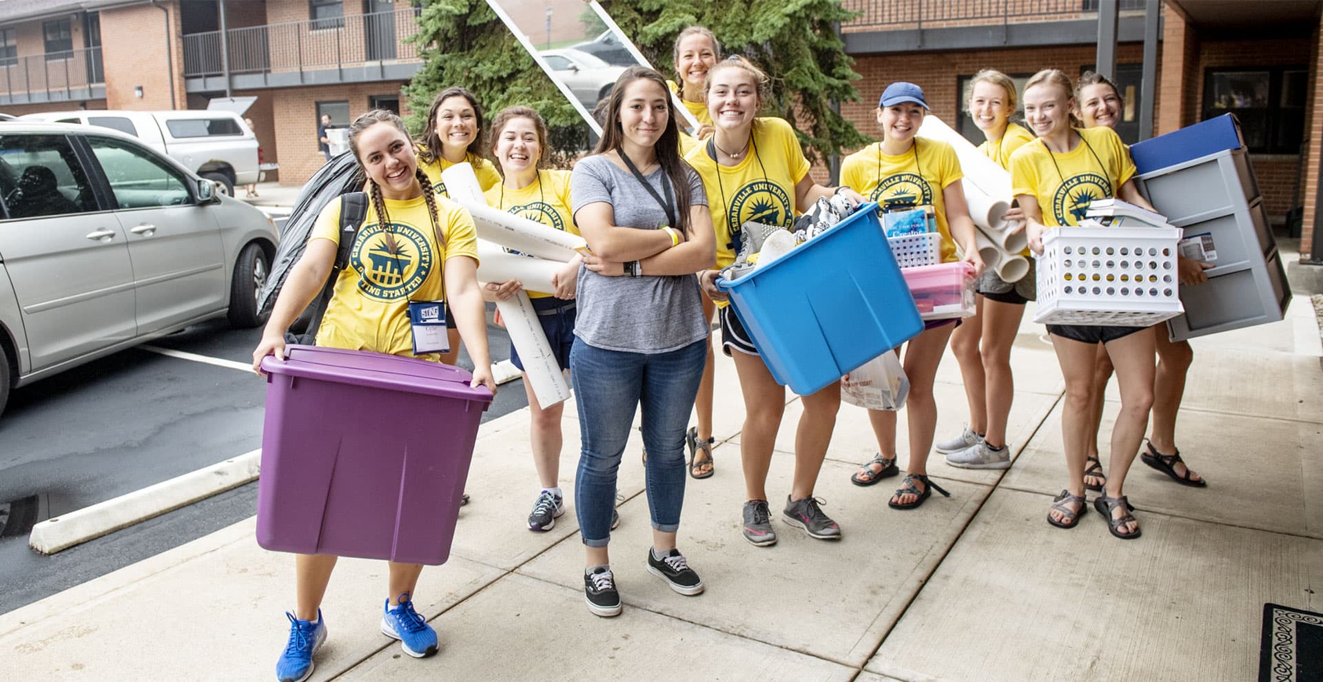 College students moving new student into Printy residence hall