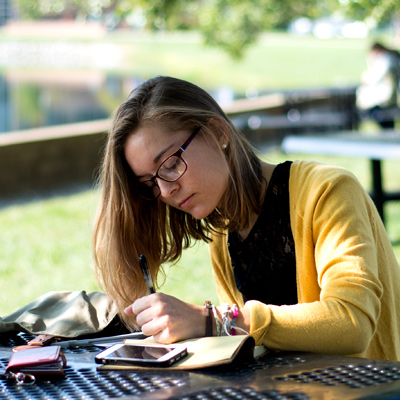 Female student writing on notepad