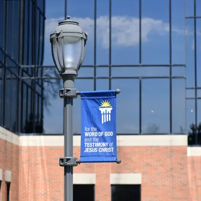 Lamp Post with For the Word of God banner in front of the Steven Students Center