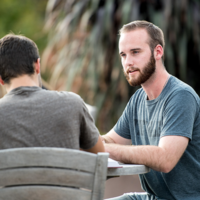 Two male students having a discussion outside the Center for Biblical and Theological Studies