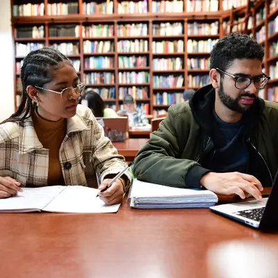 Guy and girl students studying in Wiersbe Library and Reading Room