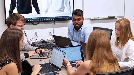 IBC business students working at a table together
