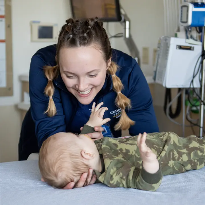 Nursing student caring for an infant.